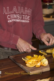 removing peel and pitch from orange's flesh to make candied orange peels
