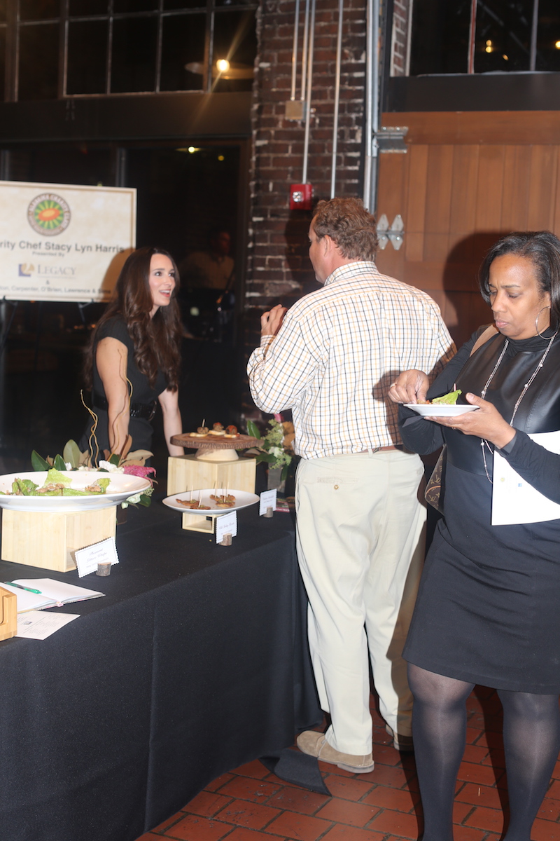 Stacy Lyn talking with one of the donors toward Baptist Health Charity Event.