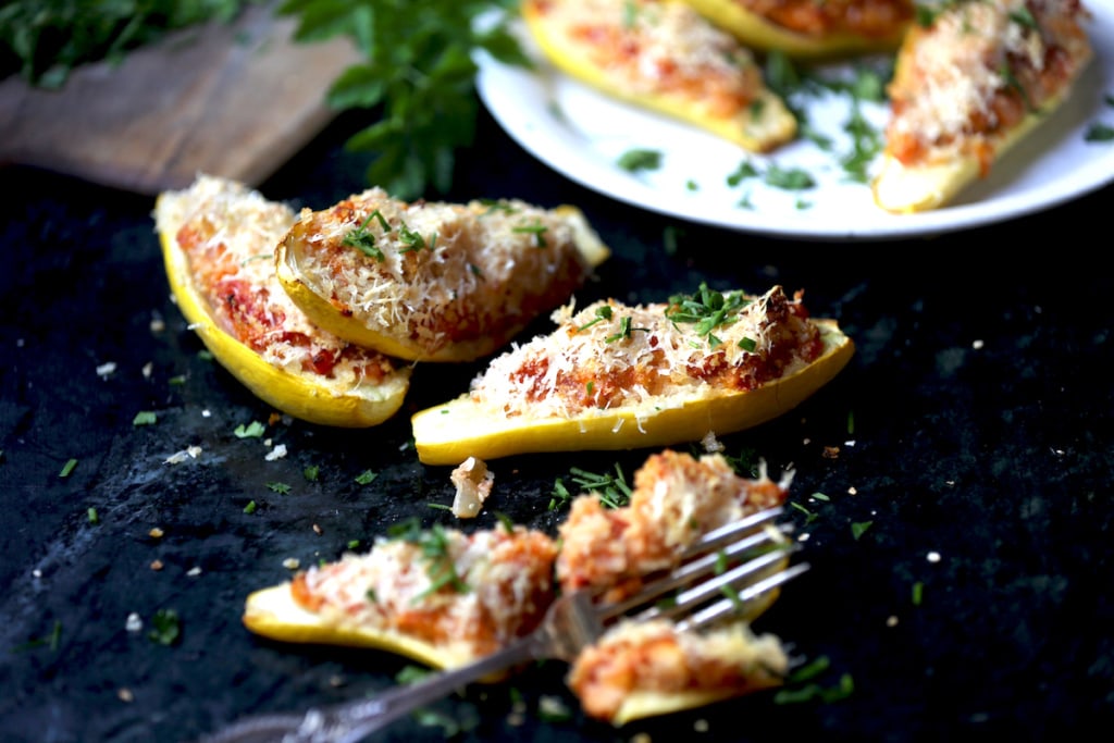 photo of summer squash boats with Italian sauce, parmesan cheese, and parsley garnish