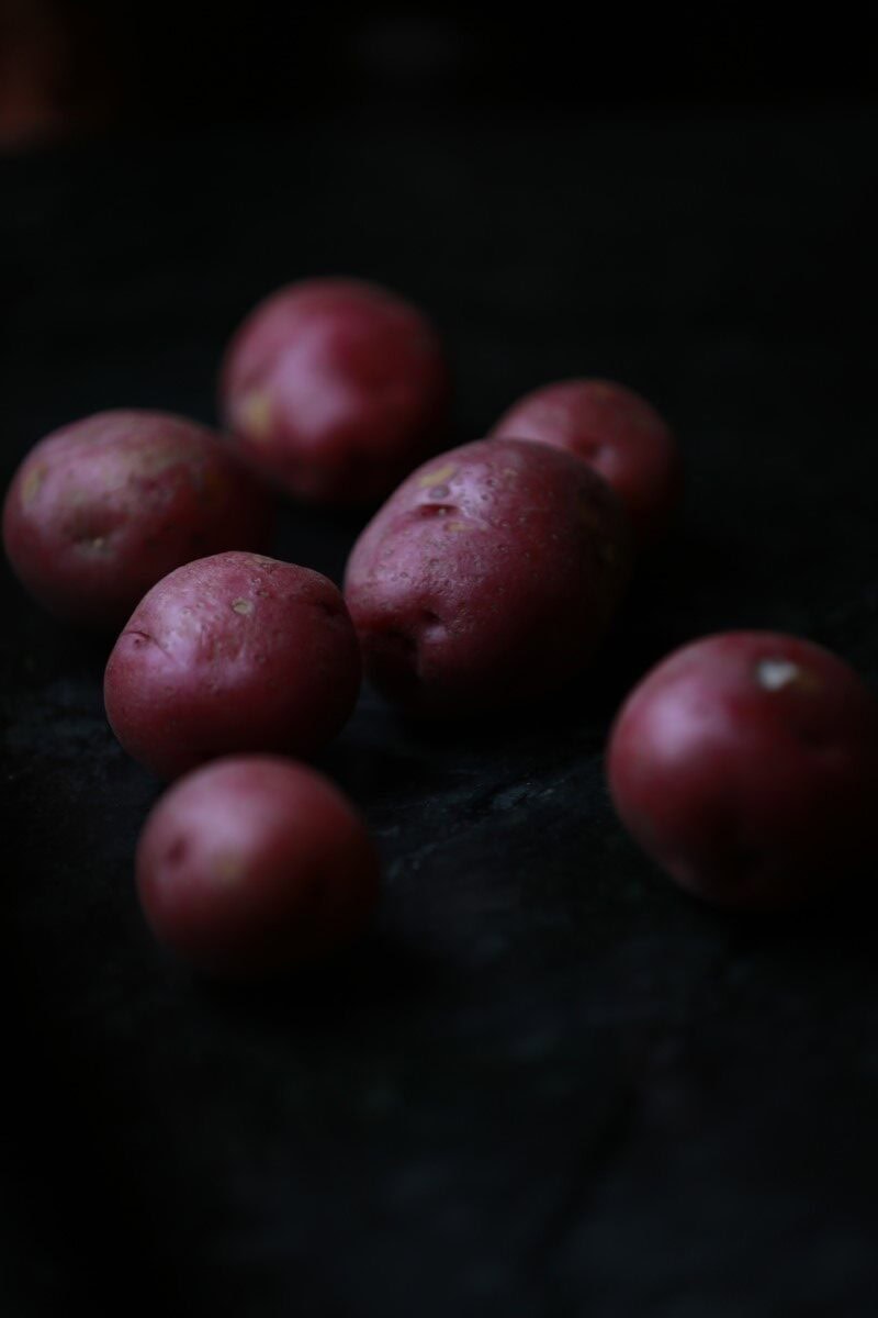 red potatoes against black background