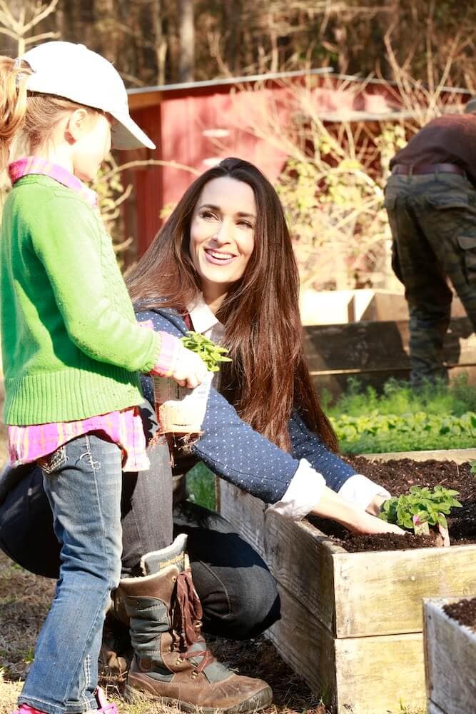 Stacy teaching her daughter how to garden