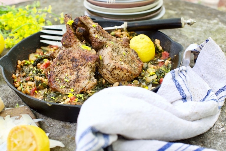 Pork choops cooked in cast iron skillet with wild plants