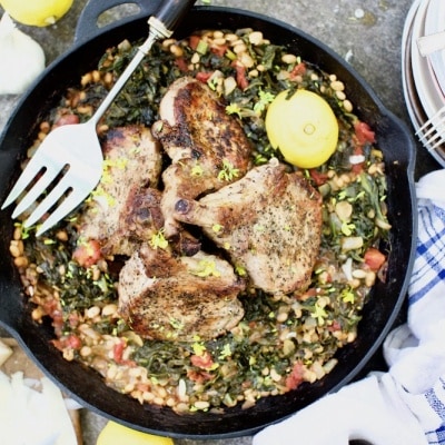 Pork chops cooked in cast iron skillet with wild plants