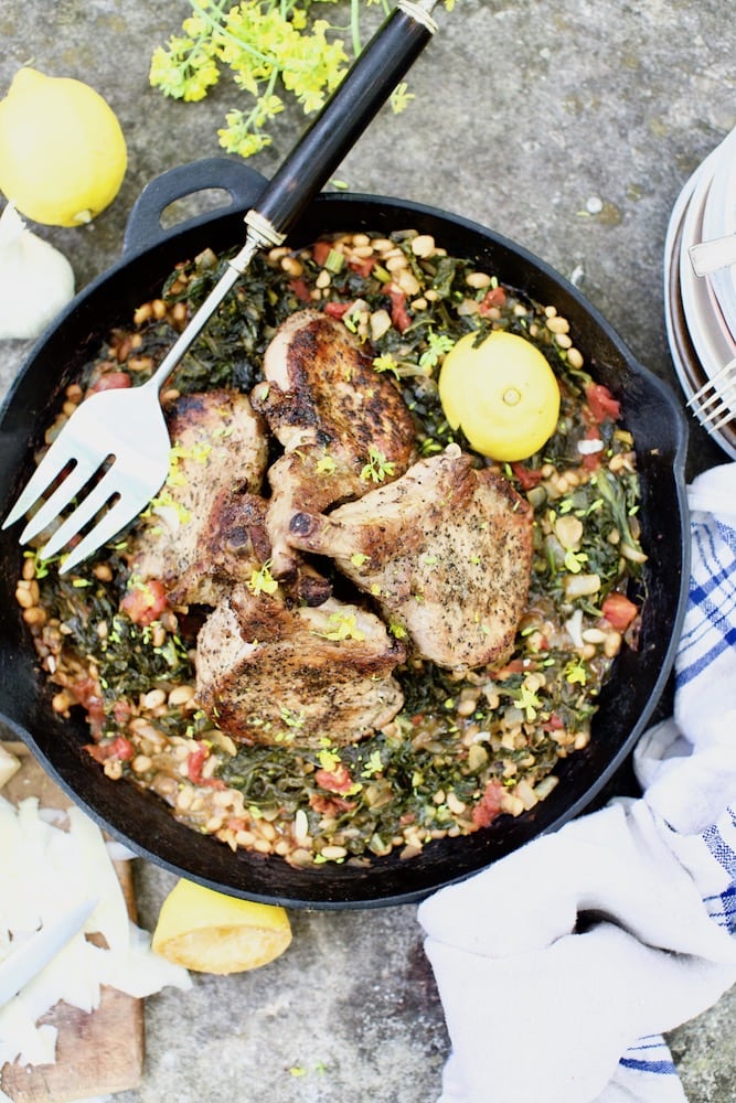 Pork chops cooked in cast iron skillet with wild plants