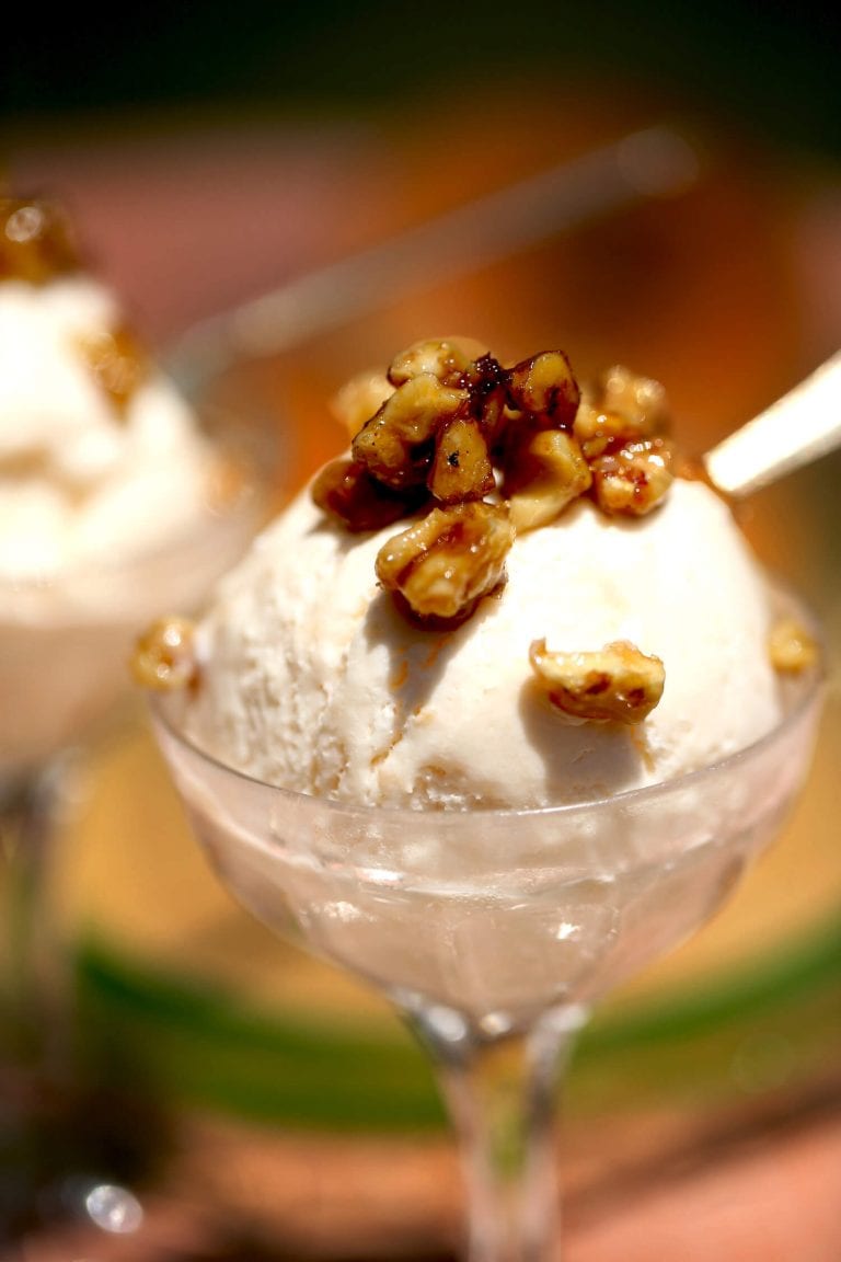 Homemade ice cream made with fresh cantaloupe topped with candied nuts, walnuts and pecans