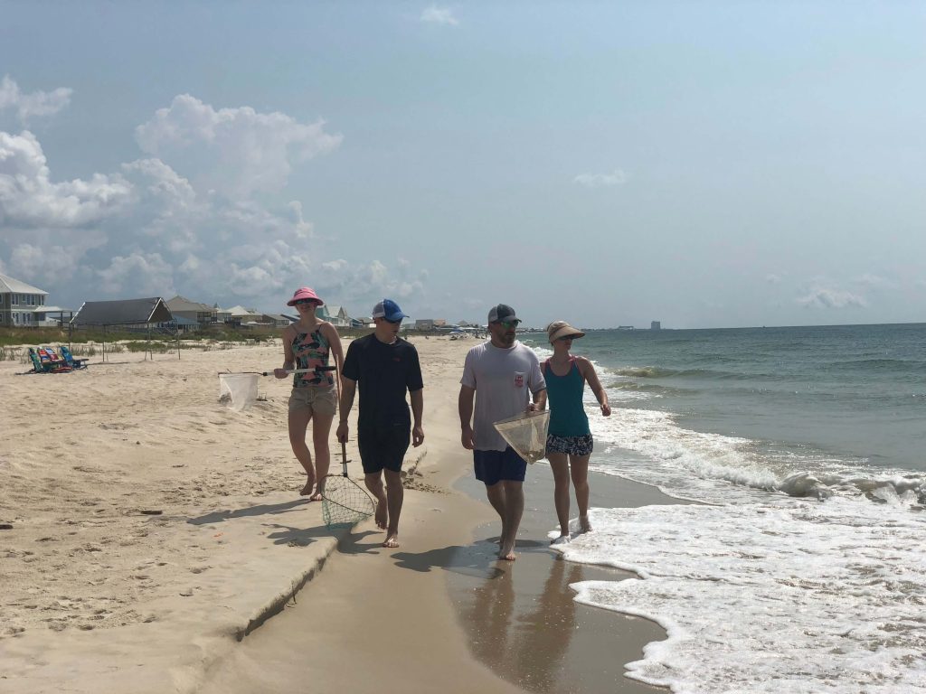 Stacy Lyn and family walking down the beach after catching crab