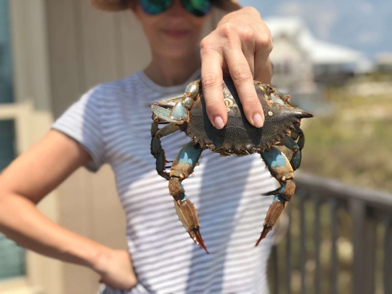 Stacy Lyn emphatically holding up a freshly caught crab