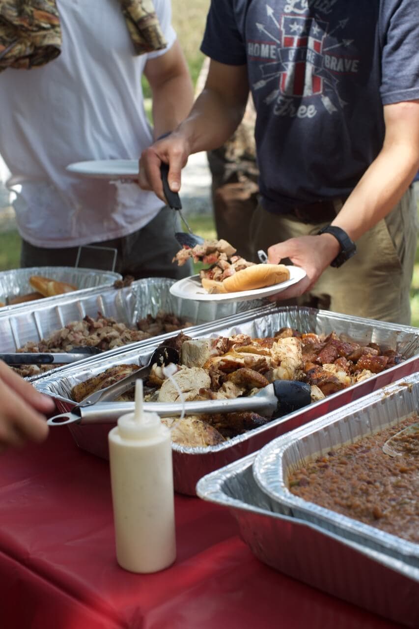 The spread of food served at the dovehunt with participants and spectators digging in