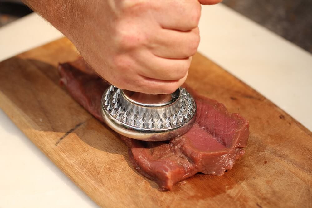 step 4 of the butterfly technique - pounding the venison loin, photo by Stacy Lyn Harris