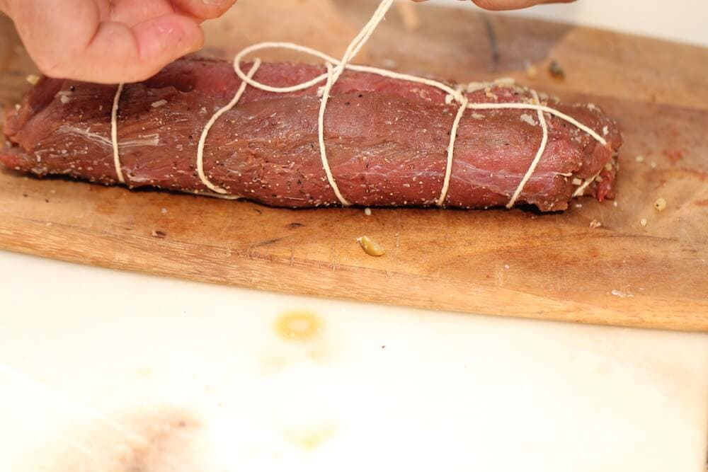 Final step of the trussing technique to stuff venison loins, photo by Stacy Lyn Harris