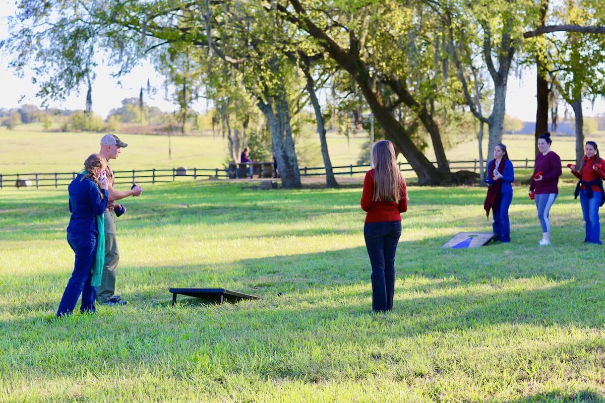 November party at the Stacy Lyn Harris household with all of her children's friends, playing corn hole and eating wild hog recipes