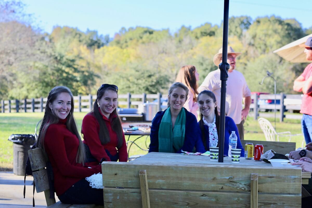 November party at the Stacy Lyn Harris household with all of her children's friends, playing corn hole and eating wild hog recipes
