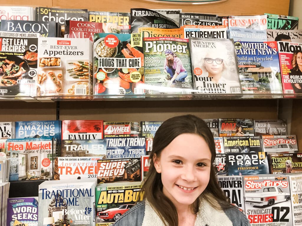 Stacy Lyn Harris and daughter seeing a copy of New Pioneer Magazine on shelves at the bookstore