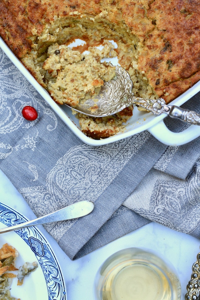 Large Spoonful of Cornbread Dressing in corner of square casserole dish