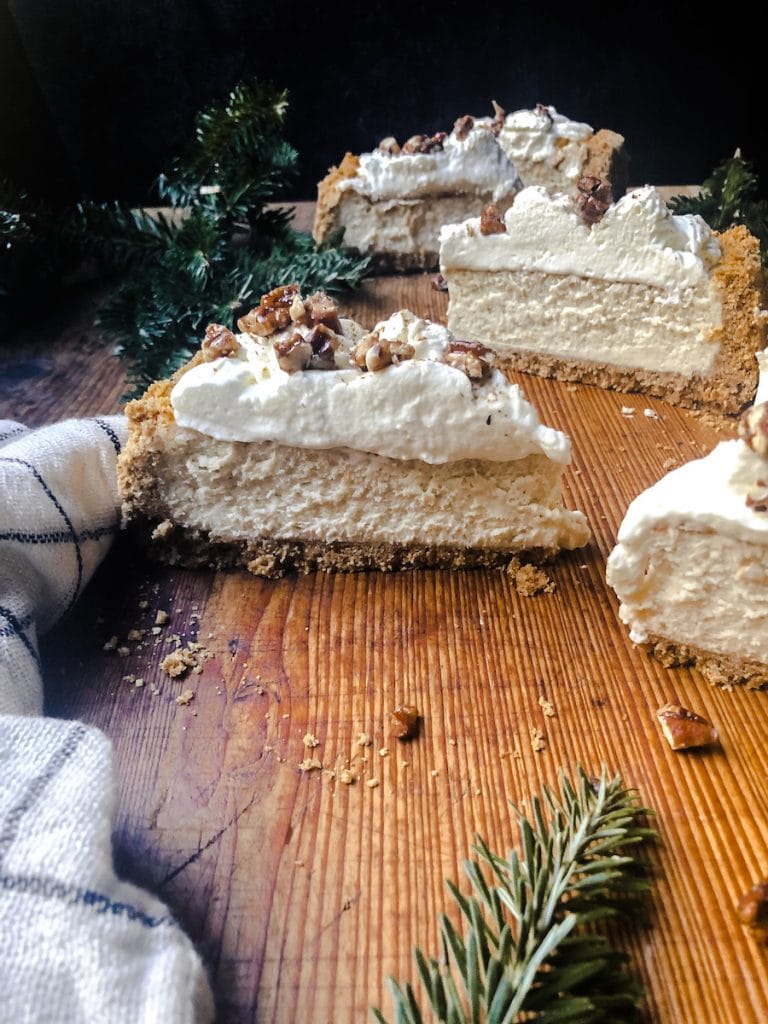 Eggnog Cheesecake on Wooden Board with Greenery