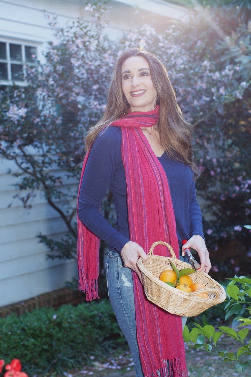 Stacy Lyn Harris in backyard with a basket of oranges
