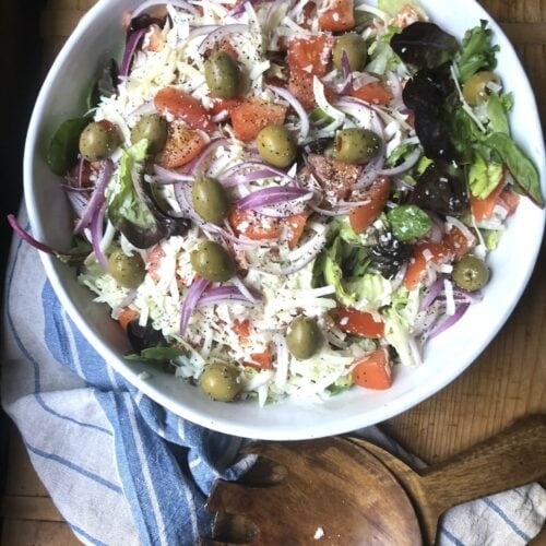 Italian salad recipe includes croutons and Parmesan tossed with fresh vegetables.
