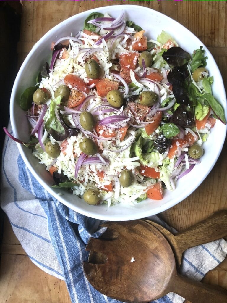 Italian salad recipe includes croutons and Parmesan tossed with fresh vegetables.