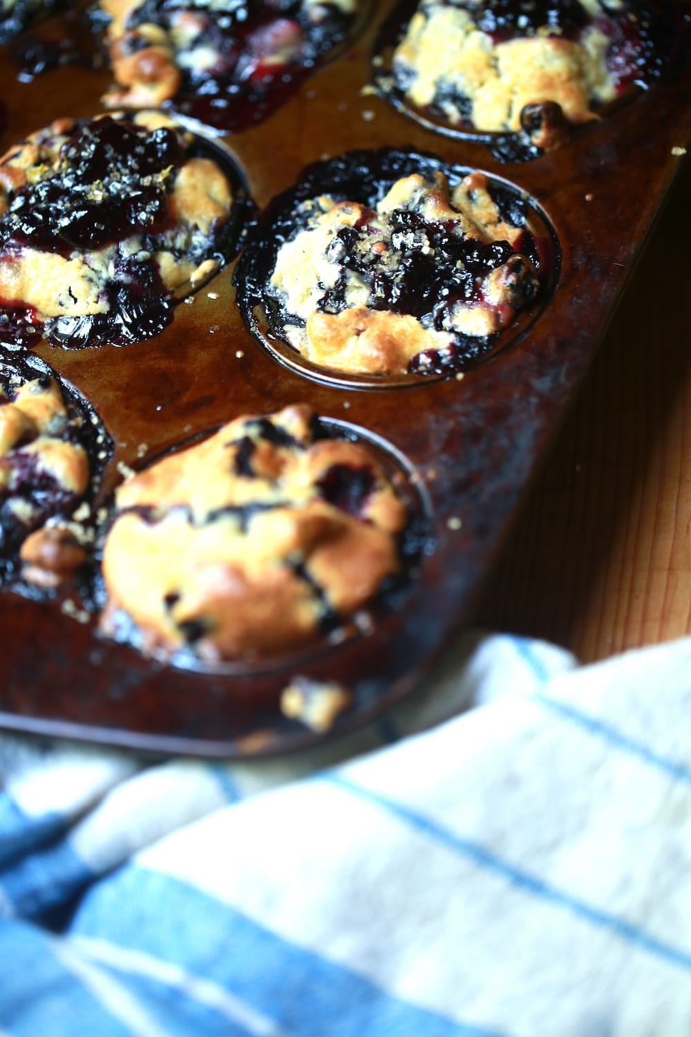 muffins in tin with gooey berry filling