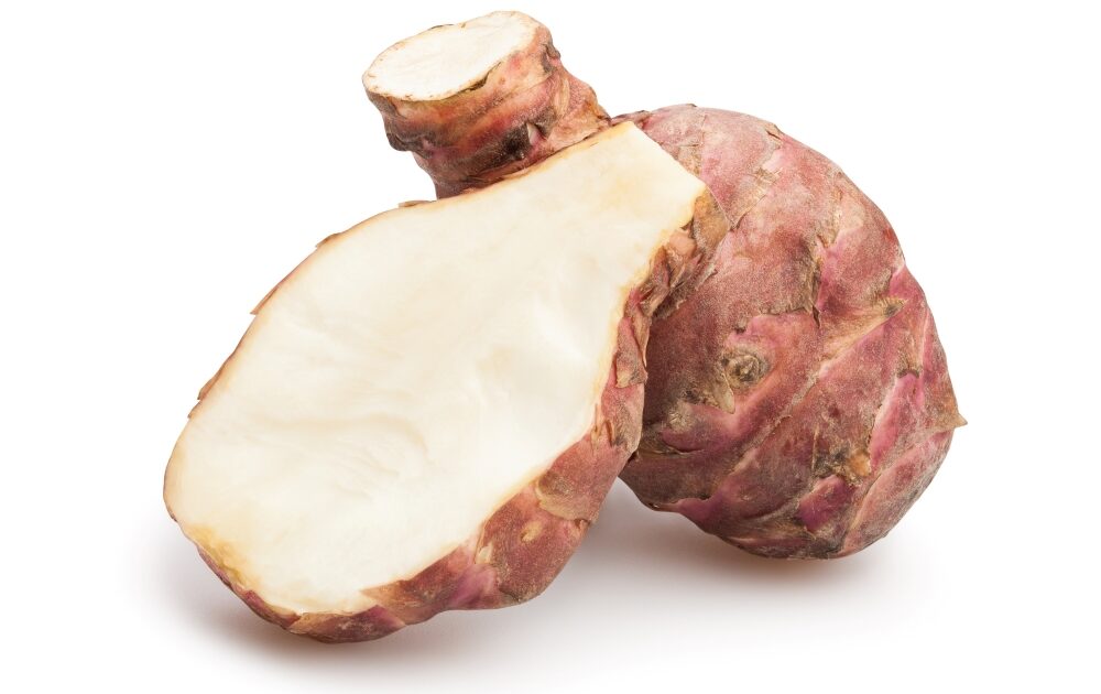 sliced Jerusalem artichoke in front of whole tuber