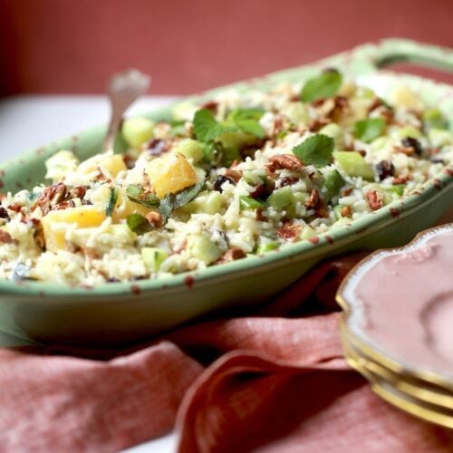 Rice Salad Recipe with Pineapple, Cucumbers, Pecans, and Bacon in green with red decorative bowl