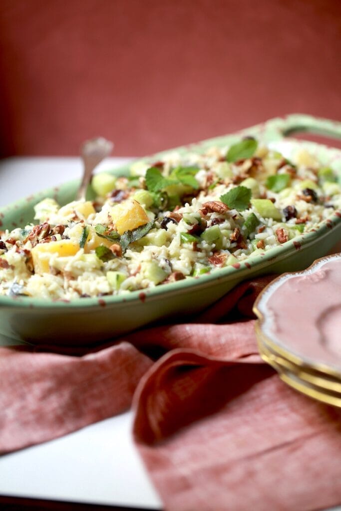 Rice Salad Recipe with Pineapple, Cucumbers, Pecans, and Bacon in green with red decorative bowl