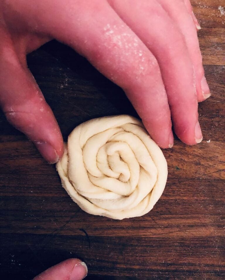 Roll one end of the spiraled dough continuously to reach the other end to make a pretty spiraled pastry.