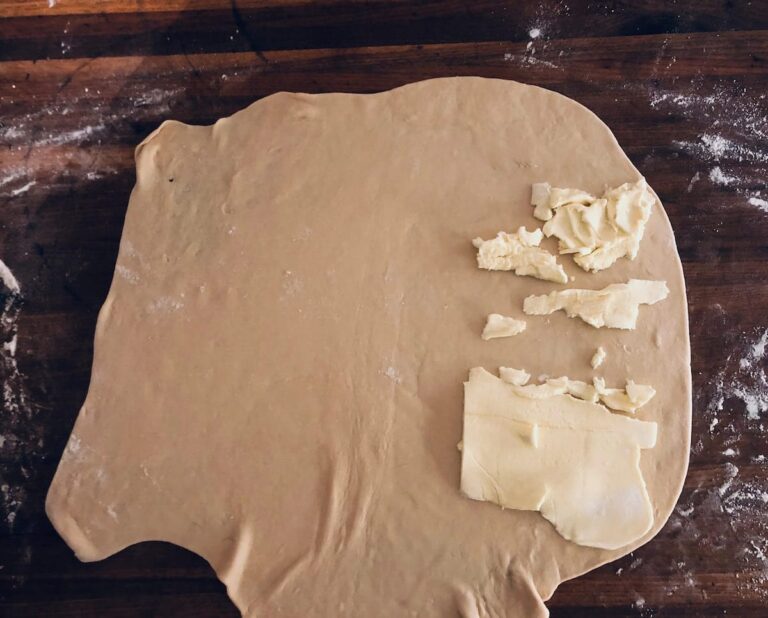 Roll dough to an approximately 20 x 20-inch square. Remove the butter from the refrigerator and place 1/2 of the butter sheet over the right side of the square.