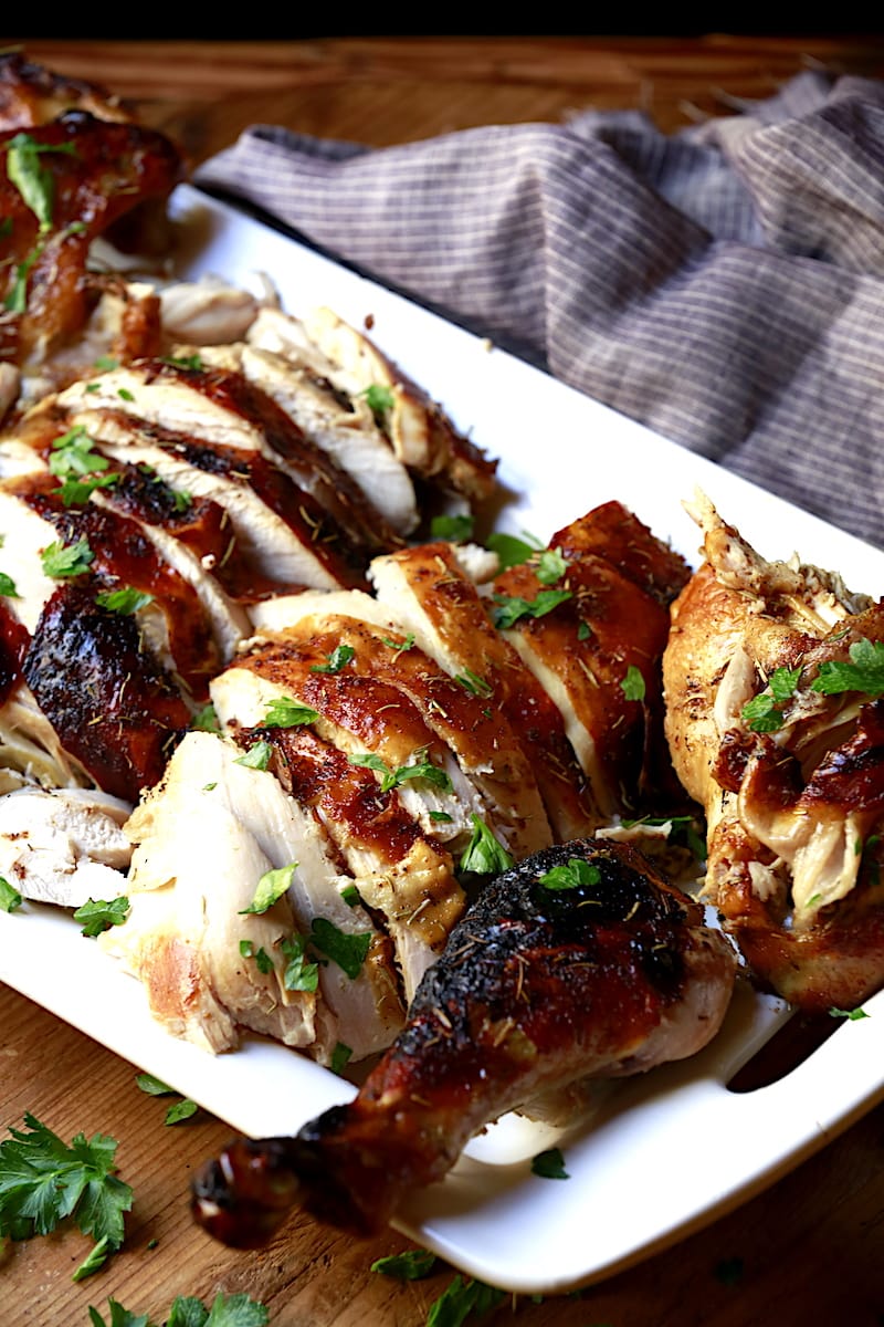 sliced roasted turkey for Thanksgiving on white platter