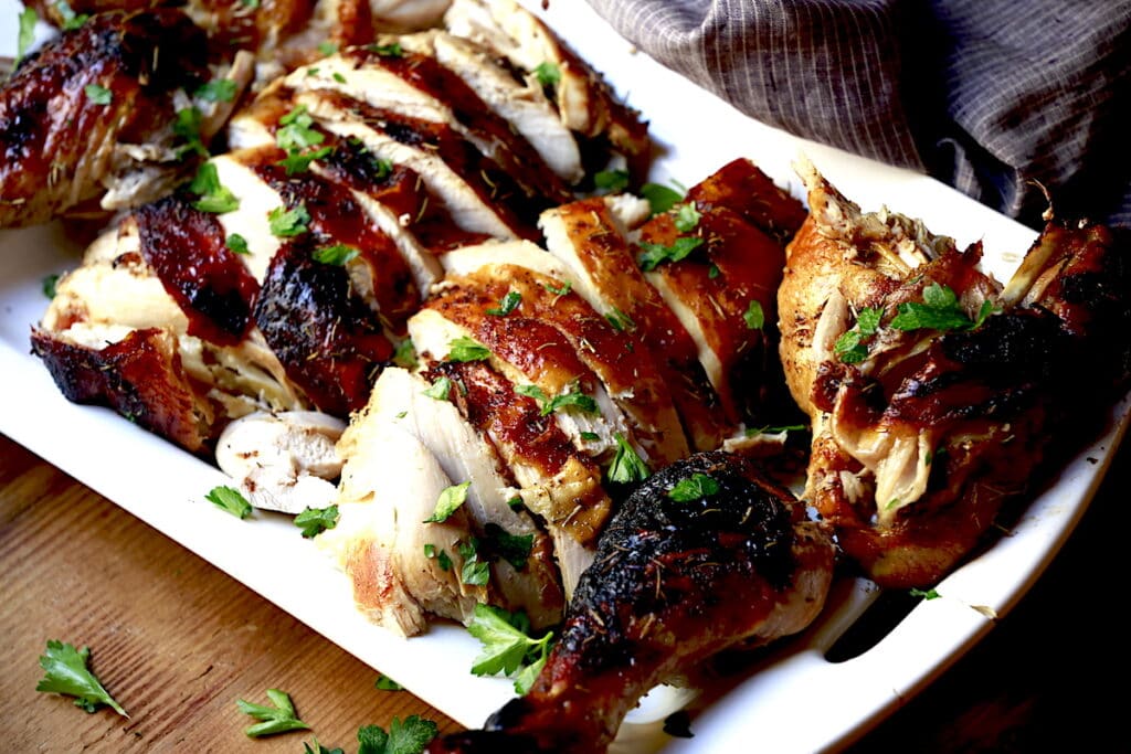sliced roasted turkey on white platter
