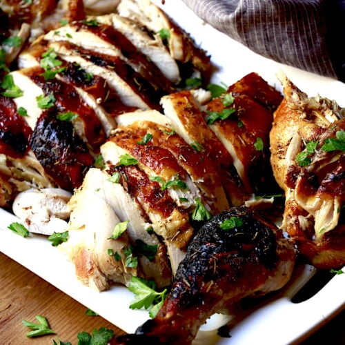 sliced roasted turkey on white platter