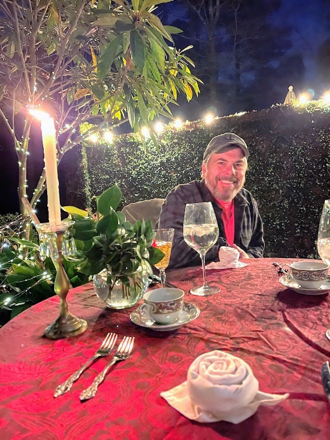 Scott smiling at outdoor anniversary dinner