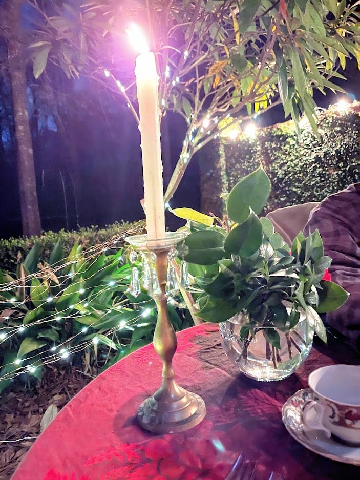 lit candle on red tablecloth outdoor - anniversary dinner table