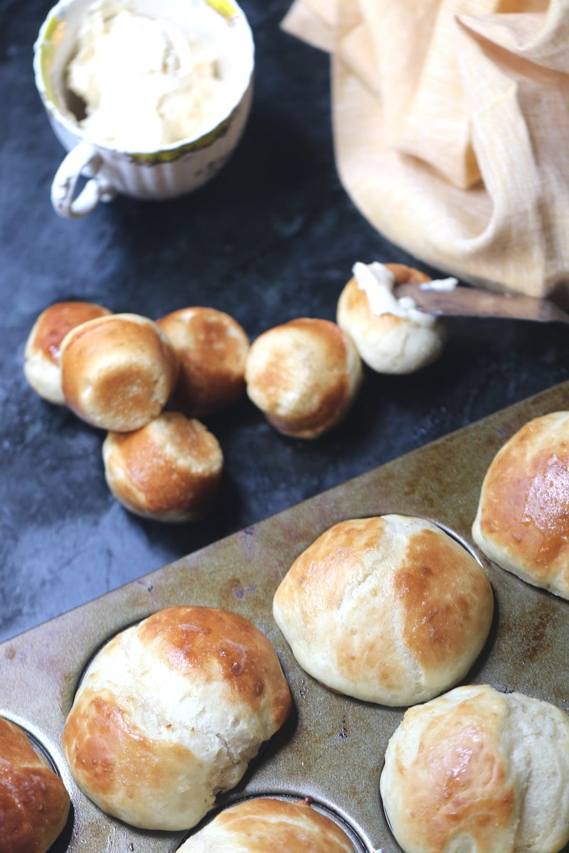yeast rolls in the pan straight from the oven with a knife slathering butter over the top