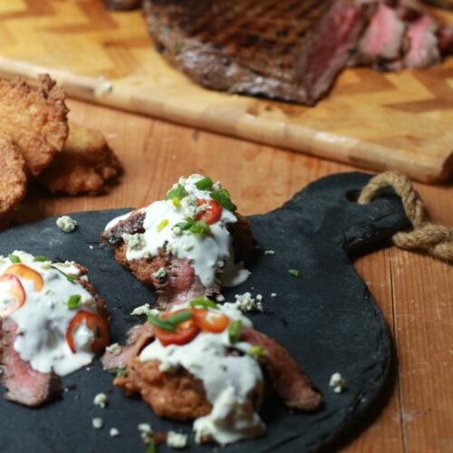 skirt steak with blue cheese crumbles and fried jalapeno cornbread on skillet