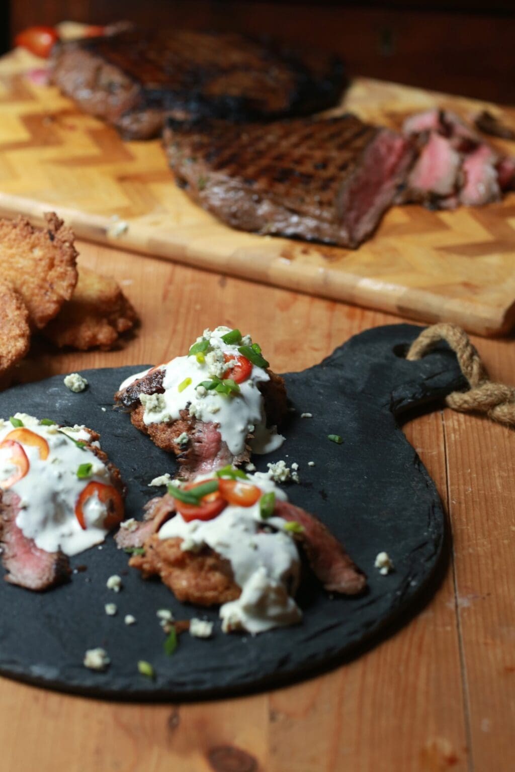 skirt steak with blue cheese crumbles and fried jalapeno cornbread on skillet