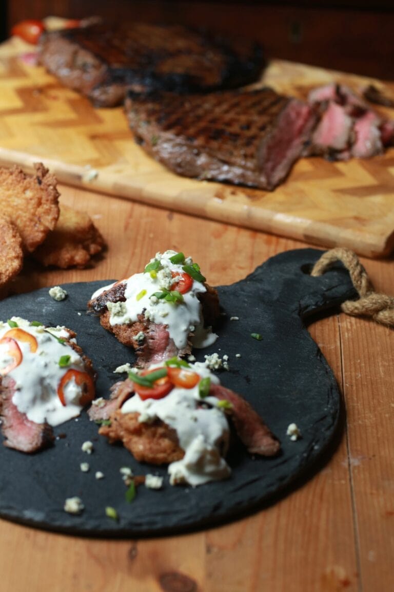 skirt steak with blue cheese crumbles and fried jalapeno cornbread on skillet