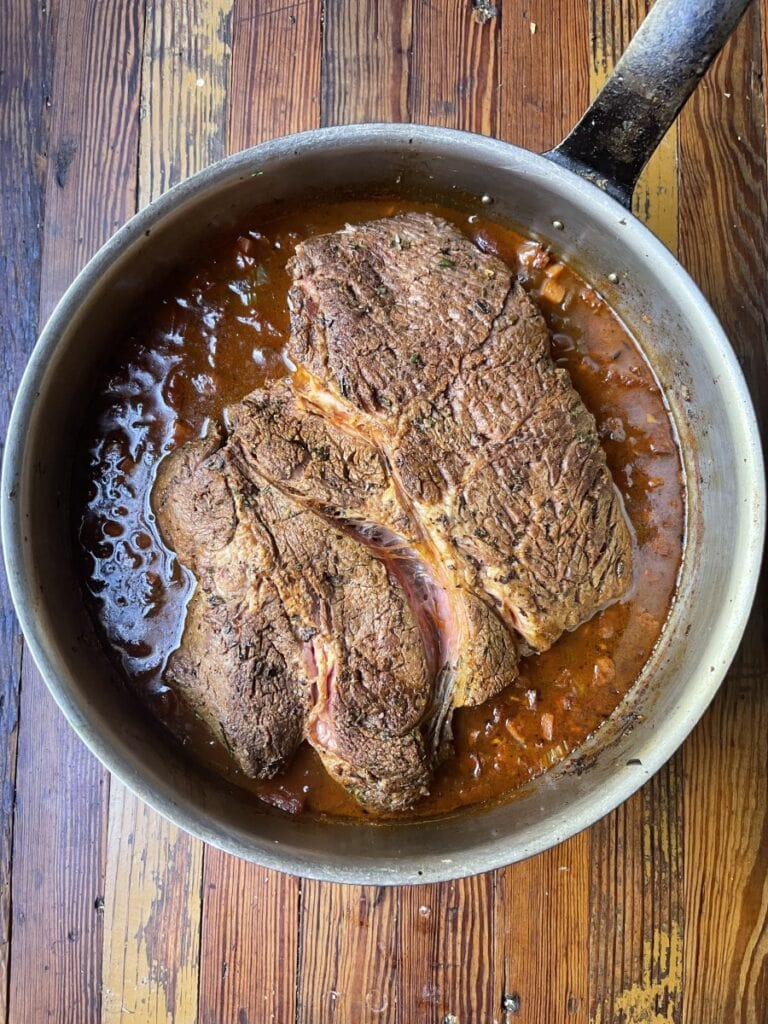 meat braising in pot