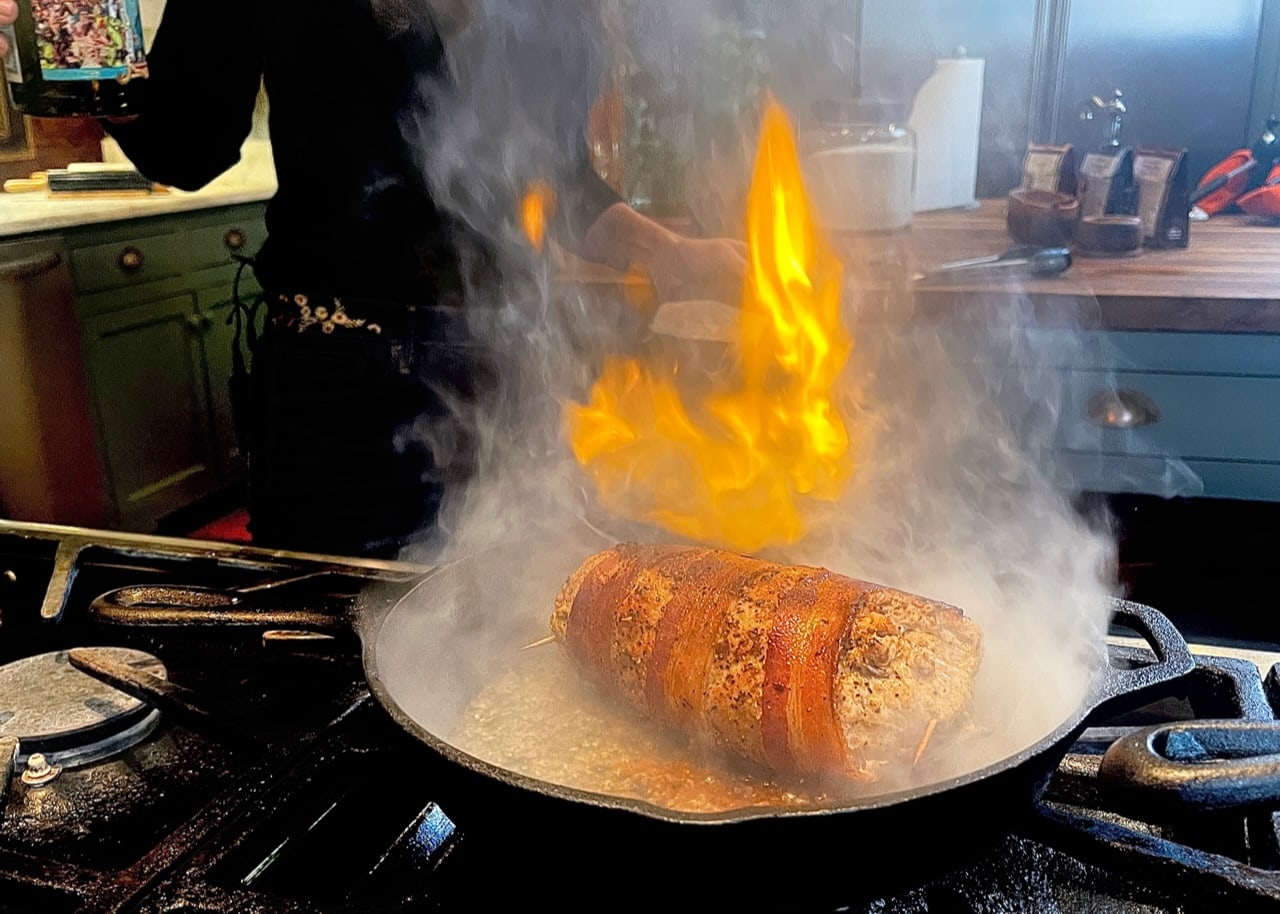Stacy Lyn preparing flaming dish in skillet for Sporting Chef