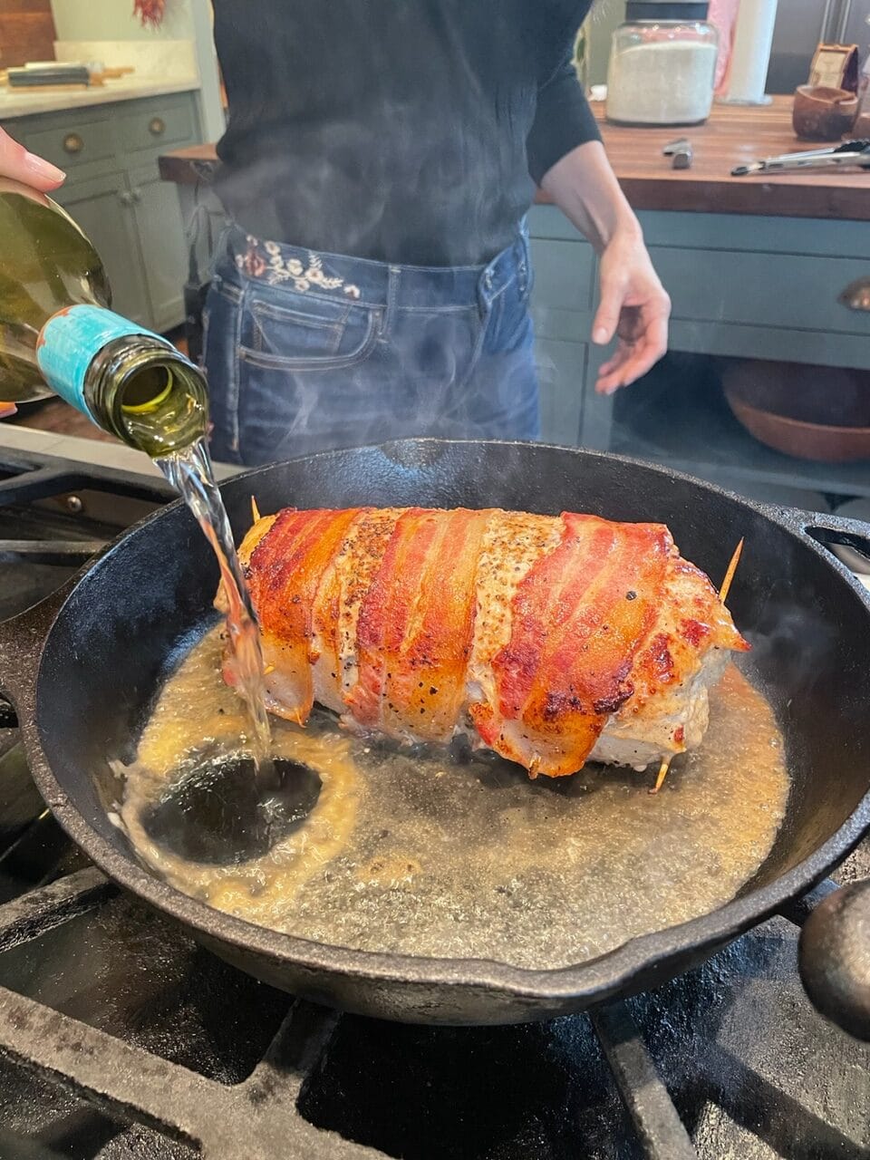 Stacy Lyn adds wine to skillet for bacon wrapped dish