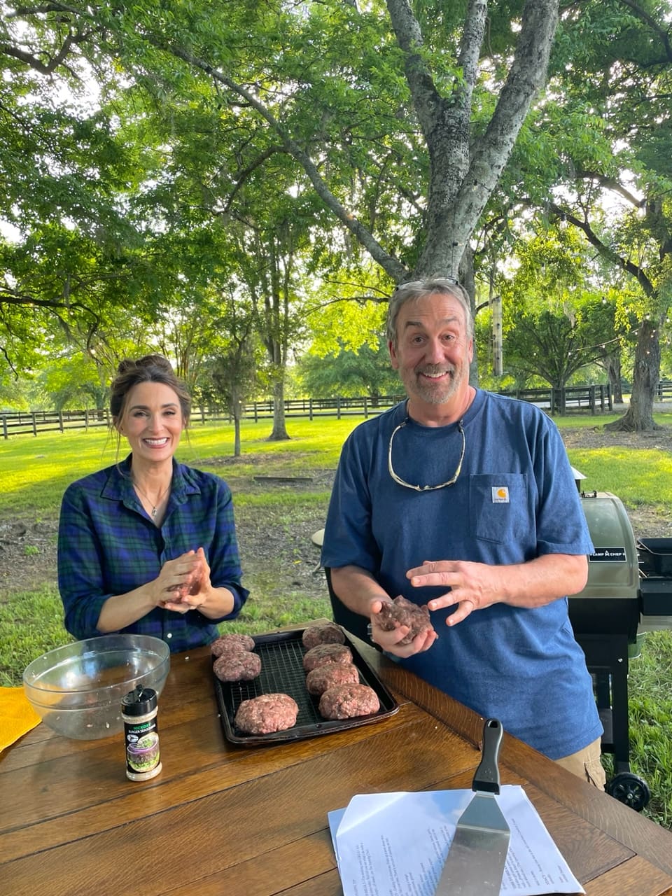 Stacy Lyn and Scott Leysath making hamburgers outdoors