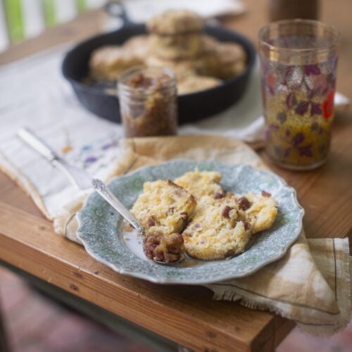 homemade bacon jam on biscuits, served on blue china plate on wood table