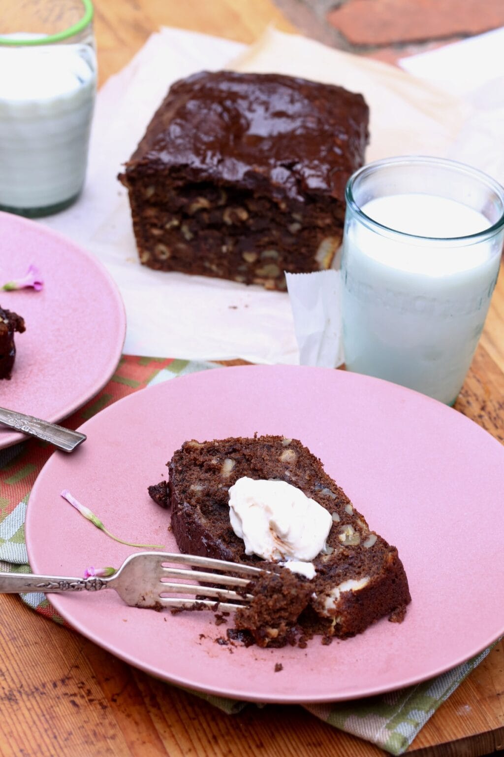 slide of chocolate banana bread with butter and fork on pink plate