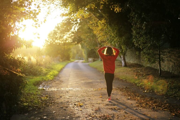 woman in red shirt seen from behind, walking