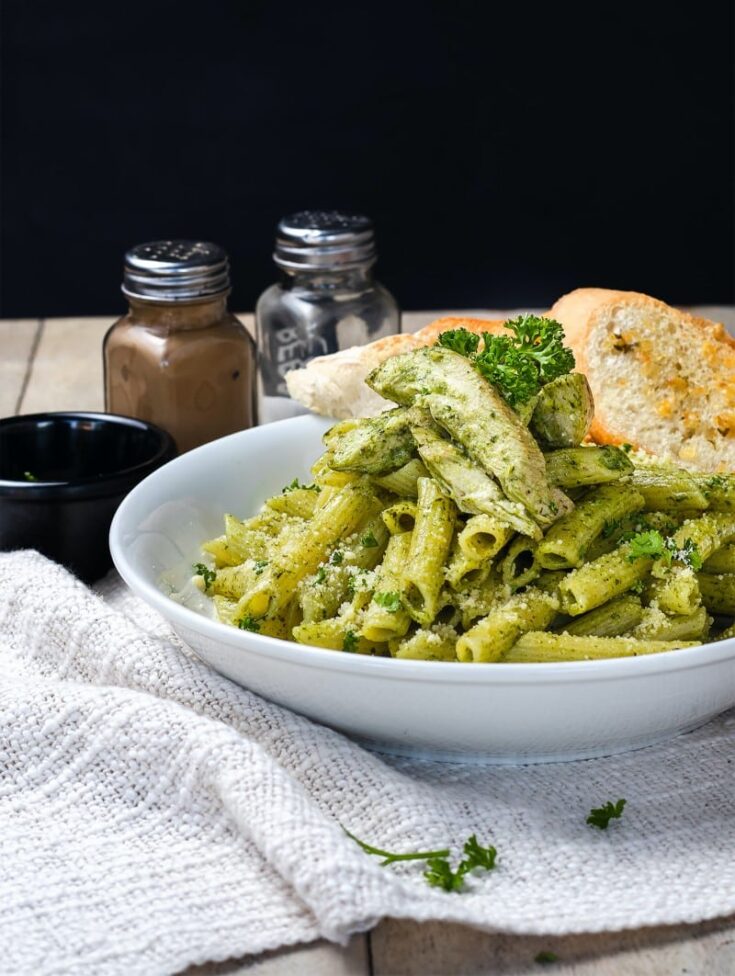 basil pesto on pasta in a while bowl