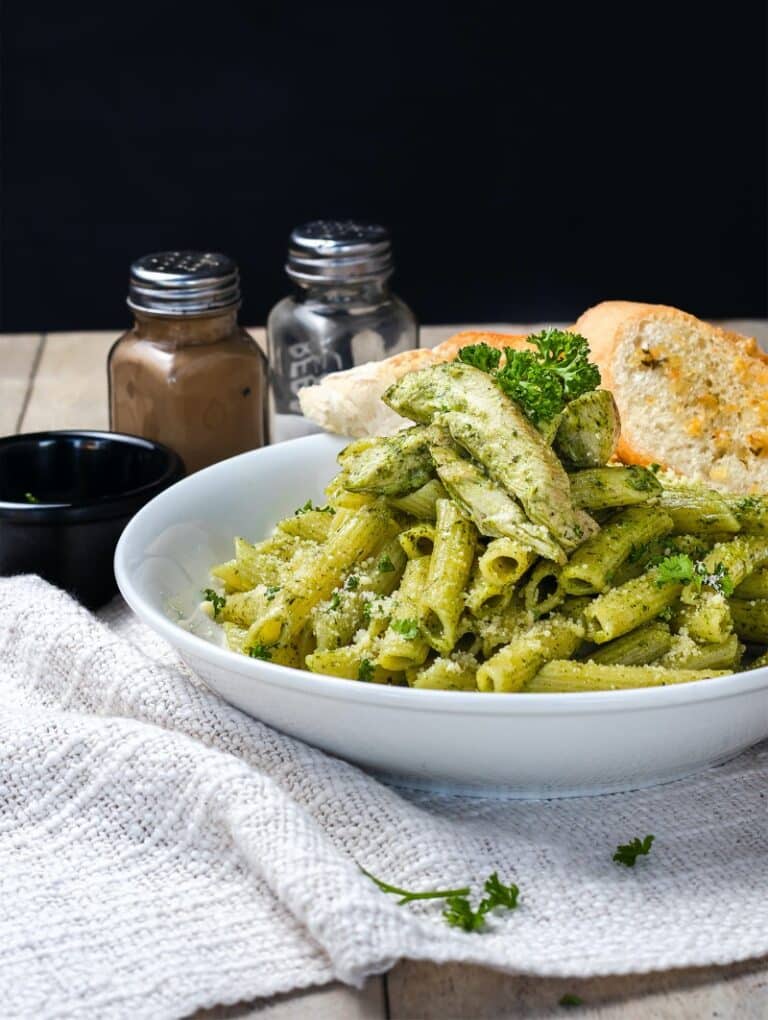 basil pesto on pasta in a while bowl