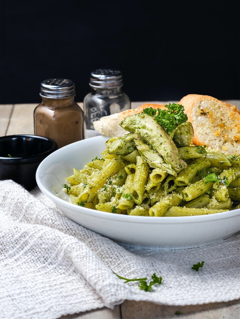 basil pesto on pasta in a while bowl