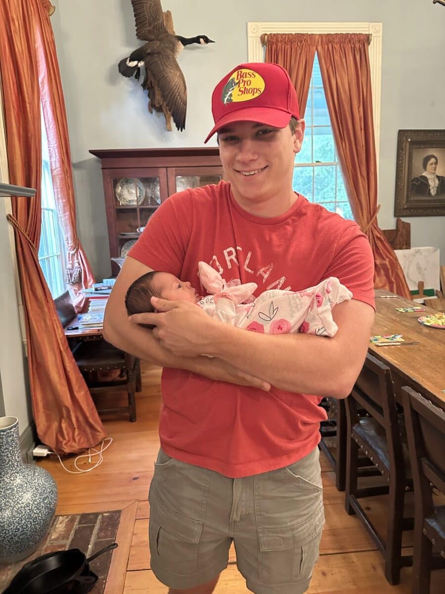 holding baby Flora at home in dining room