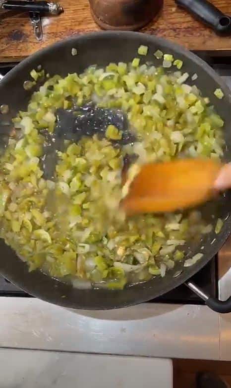 stirring green tomato relish as it cooks in pan