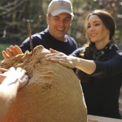 Stacy Lyn and Scott shaping the earthen oven dome shape with wet sand